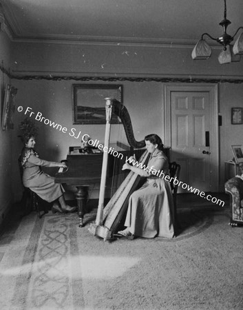 MRS MC CABE AND EILEEN  PLAYING HARP AND PIANO